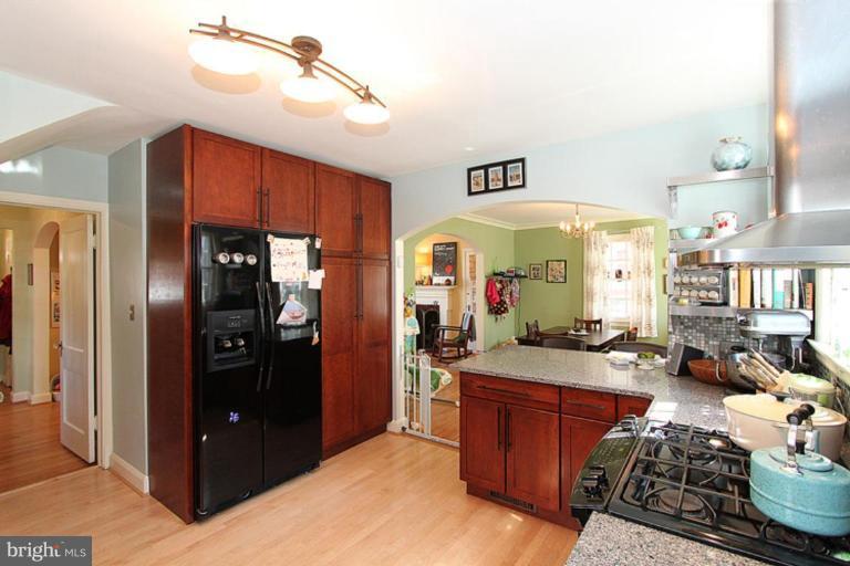 804 Rowen Road Silver Spring, MD 20910 - Photo 9 of 22 a kitchen with stainless steel appliances granite countertop a refrigerator and stove