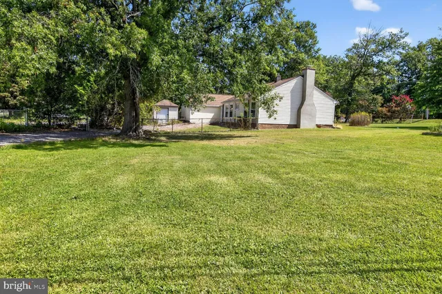 a front view of house with yard and trees