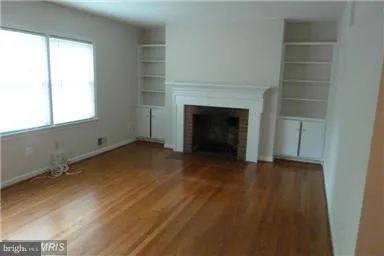 a view of empty room with a fireplace