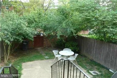 a view of a chair and table in backyard