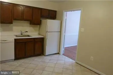 a kitchen with a refrigerator and a sink