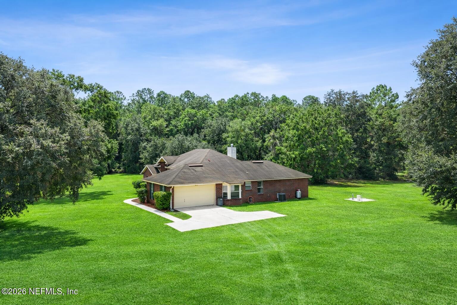 2064 Louie Carter Road Jacksonville, FL 32234 - Photo 2 of 46 a aerial view of a house with a yard table and chairs