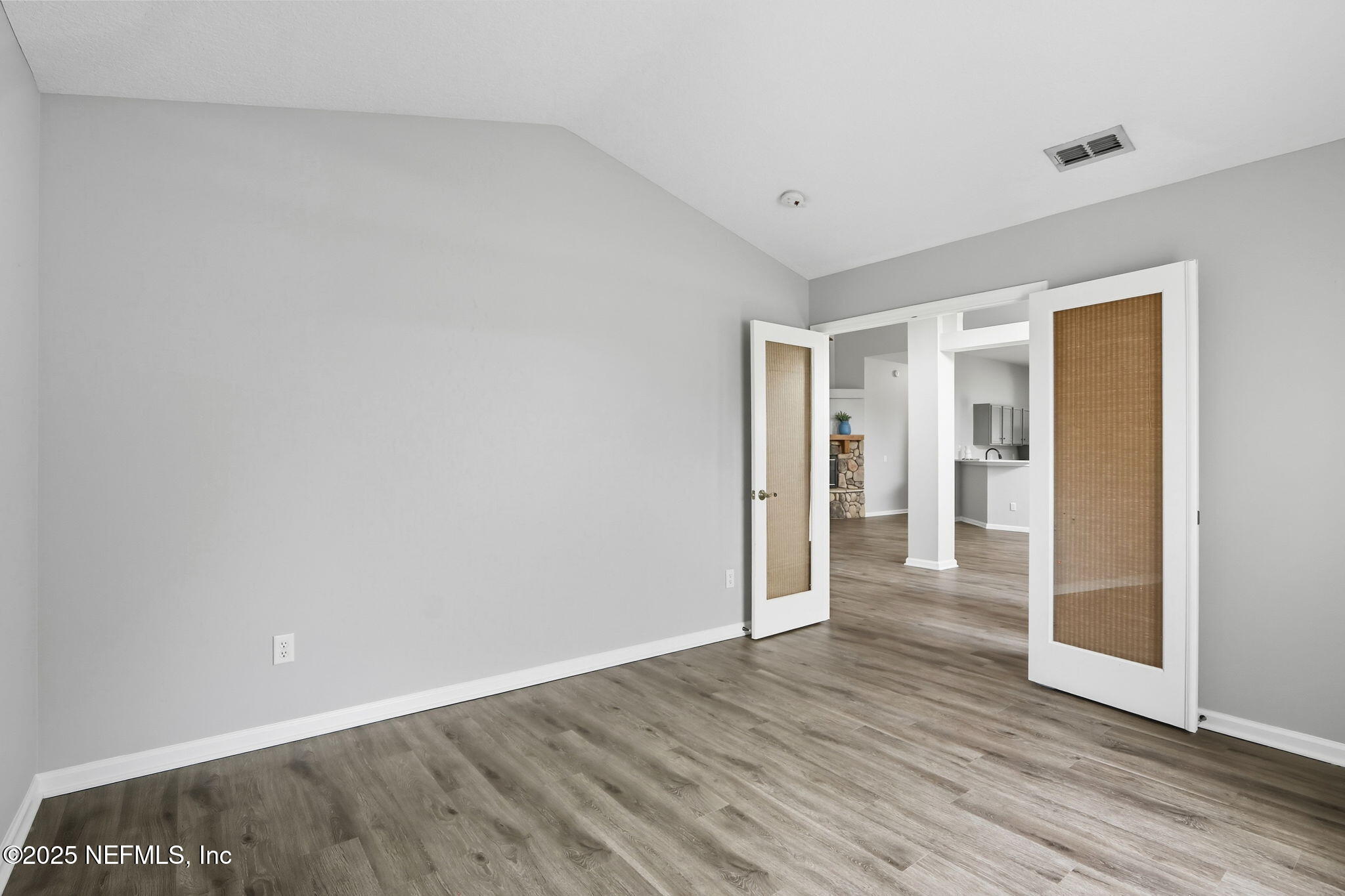 2064 Louie Carter Road Jacksonville, FL 32234 - Photo 21 of 46 a view of an empty room with wooden floor and a window
