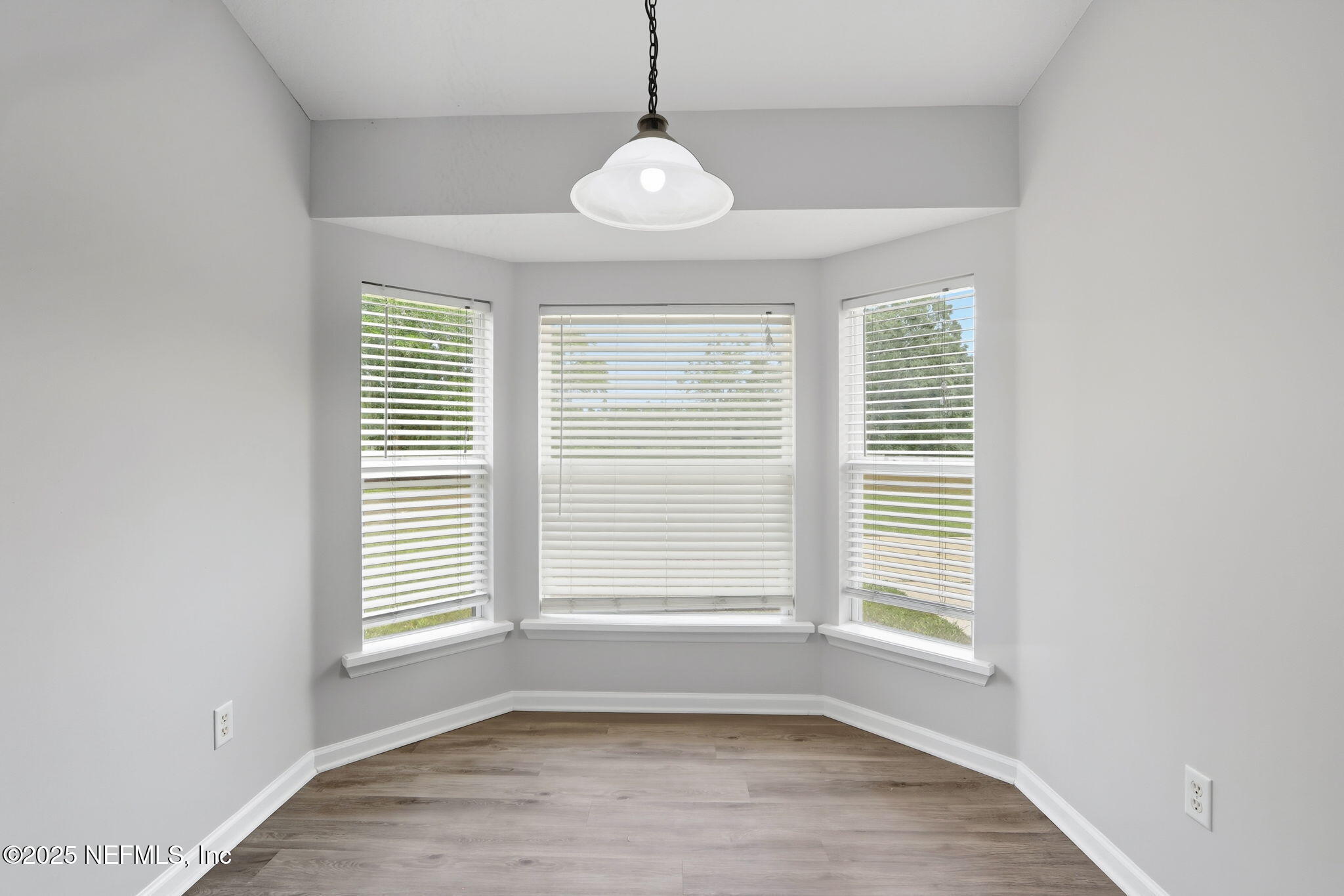 2064 Louie Carter Road Jacksonville, FL 32234 - Photo 24 of 46 a view of an empty room with a window and wooden floor