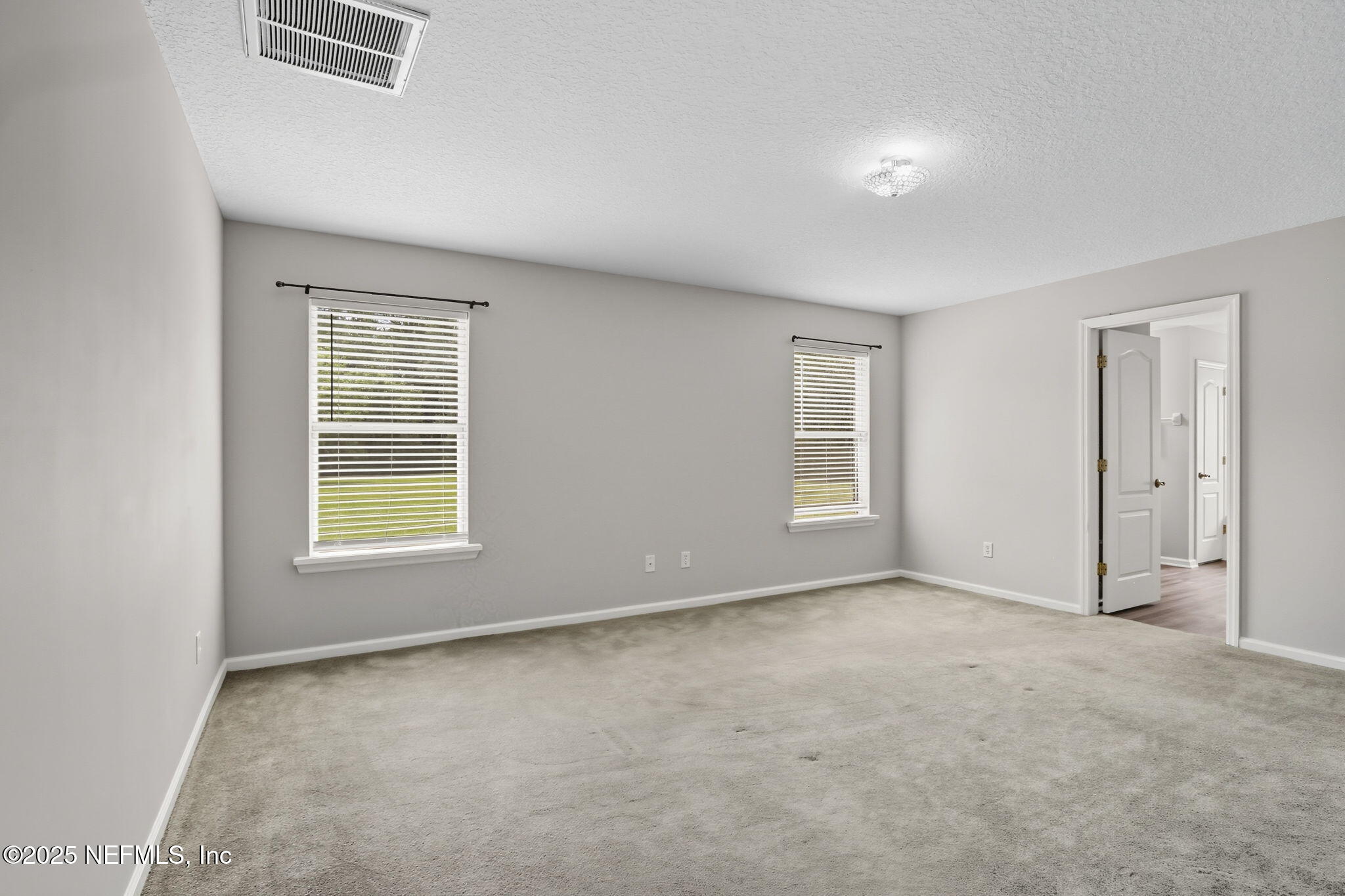 2064 Louie Carter Road Jacksonville, FL 32234 - Photo 28 of 46 an empty room with windows