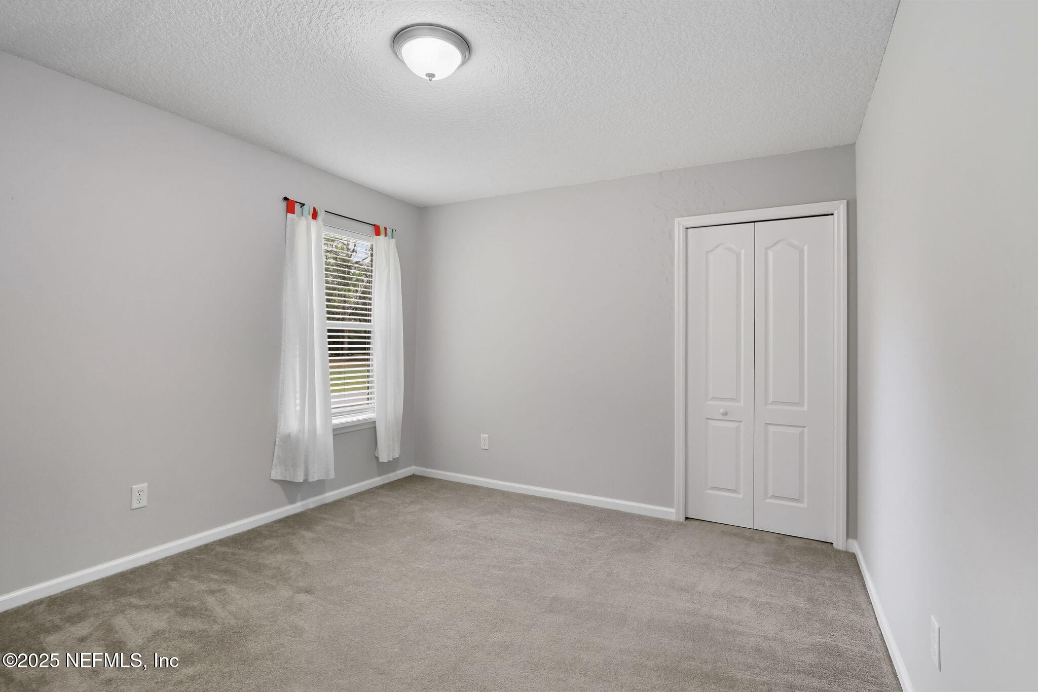 2064 Louie Carter Road Jacksonville, FL 32234 - Photo 34 of 46 an empty room with windows
