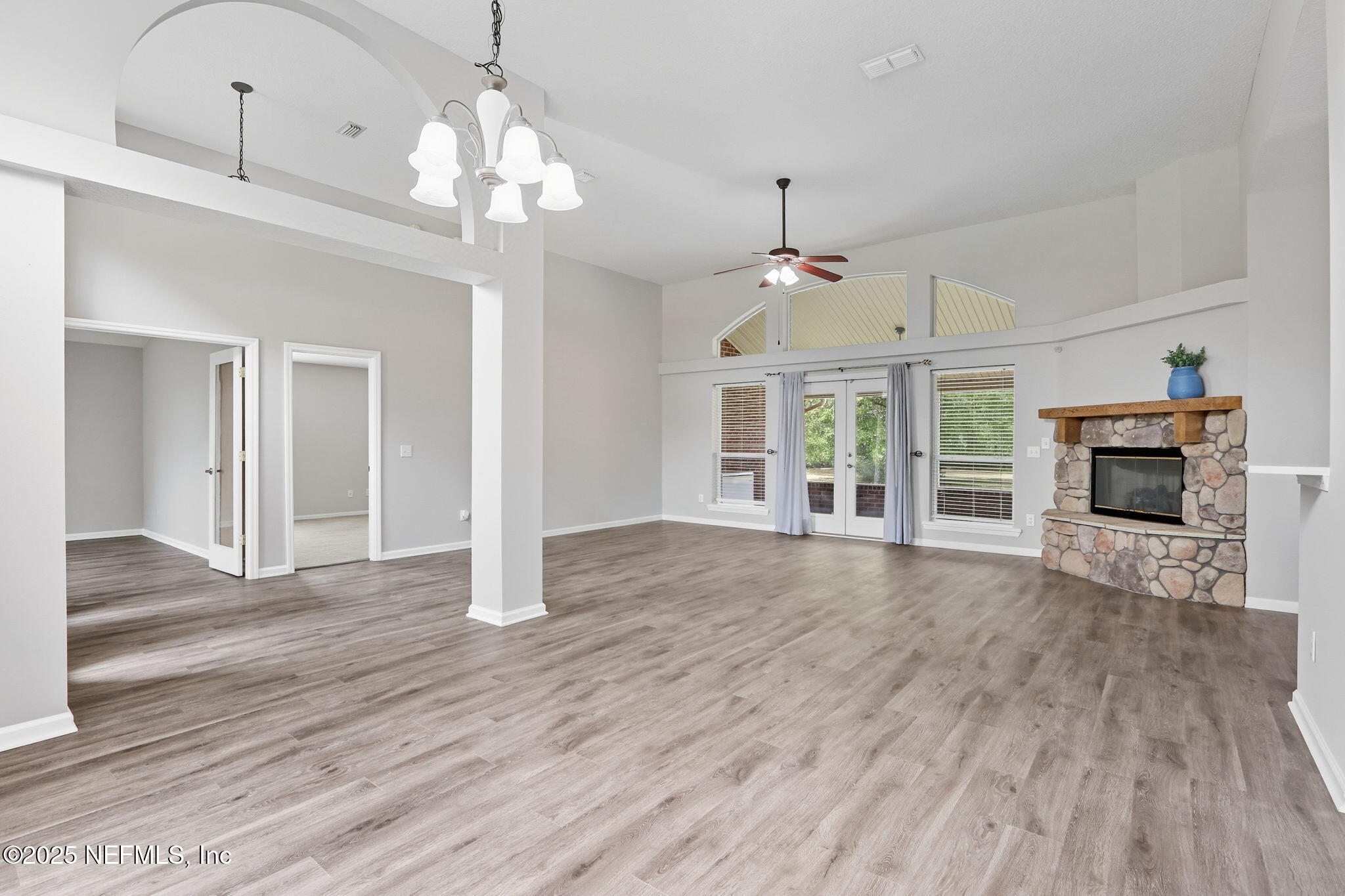 2064 Louie Carter Road Jacksonville, FL 32234 - Photo 4 of 46 a view of a livingroom with a fireplace wooden floor and a ceiling fan