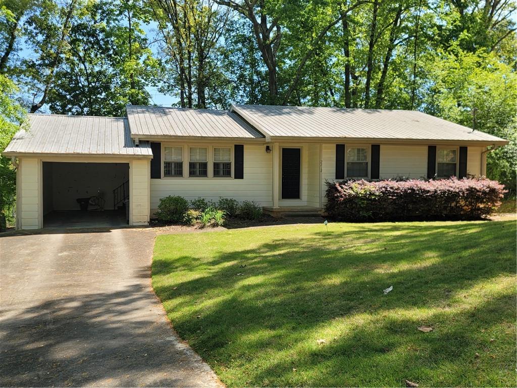 2212 Colonial Circle Gainesville, GA 30501 - Photo 1 of 57 a front view of a house with garden