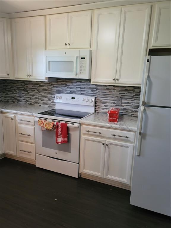 2212 Colonial Circle Gainesville, GA 30501 - Photo 11 of 57 a kitchen with white cabinets and white appliances
