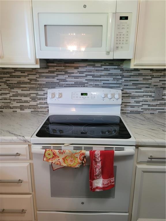 2212 Colonial Circle Gainesville, GA 30501 - Photo 13 of 57 a stove top oven sitting inside of a kitchen