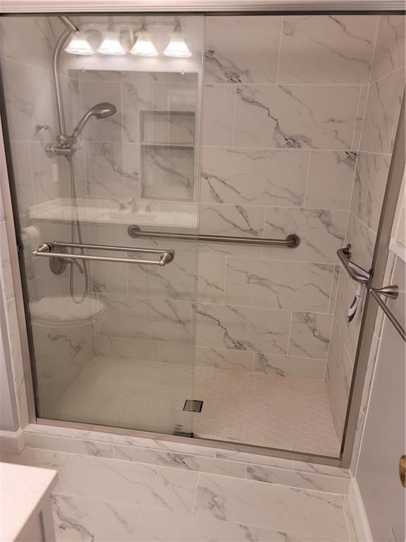 2212 Colonial Circle Gainesville, GA 30501 - Photo 30 of 57 a bathroom with a glass shower door