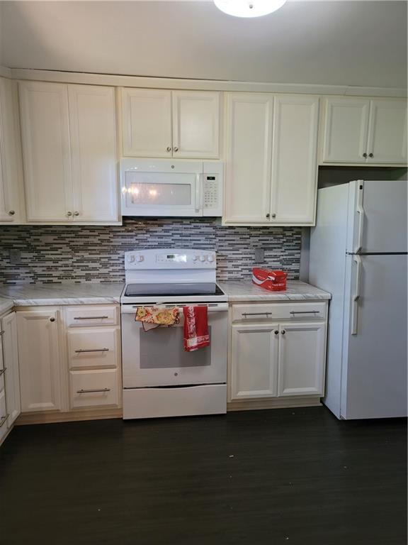 2212 Colonial Circle Gainesville, GA 30501 - Photo 8 of 57 a kitchen with white cabinets and white appliances