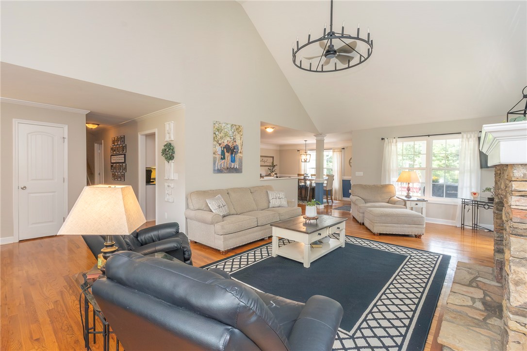 861 North Old Pendleton Road Liberty, SC 29657 - Photo 7 of 45 Hardwood floors and vaulted ceilings elevate this spacious living area with a stone fireplace.