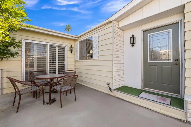 a balcony with table and chairs