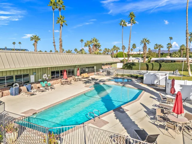 a view of a swimming pool and outdoor seating