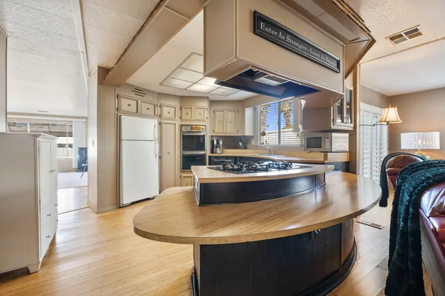 a view of kitchen with stainless steel appliances granite countertop a stove a refrigerator and a dining table