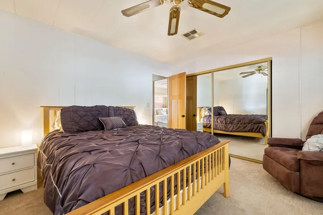 a bedroom with a bed couch and window