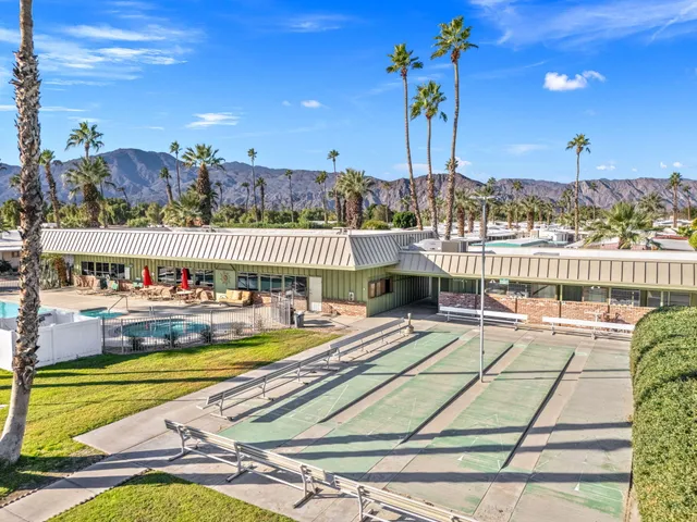 a view of a swimming pool with a terrace and seating area