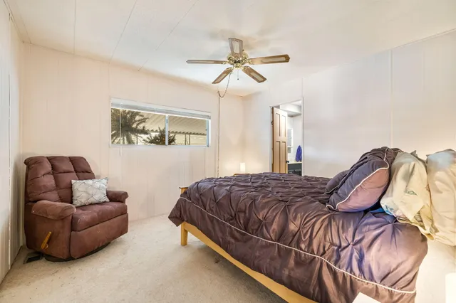 a bedroom with a bed couch and window