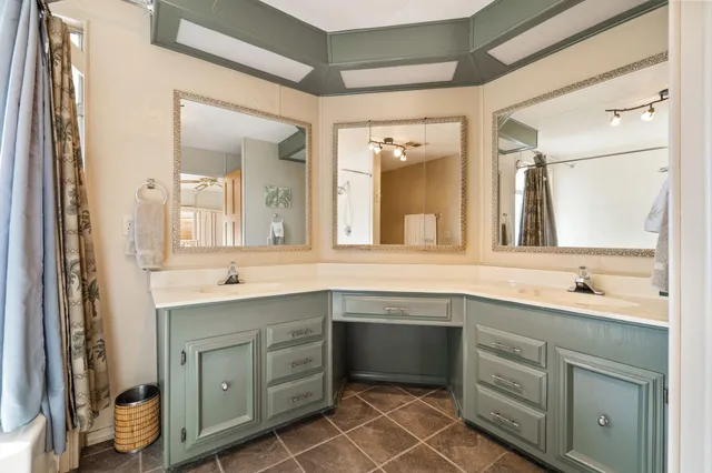 a spacious bathroom with a double vanity sink a mirror and a bathtub