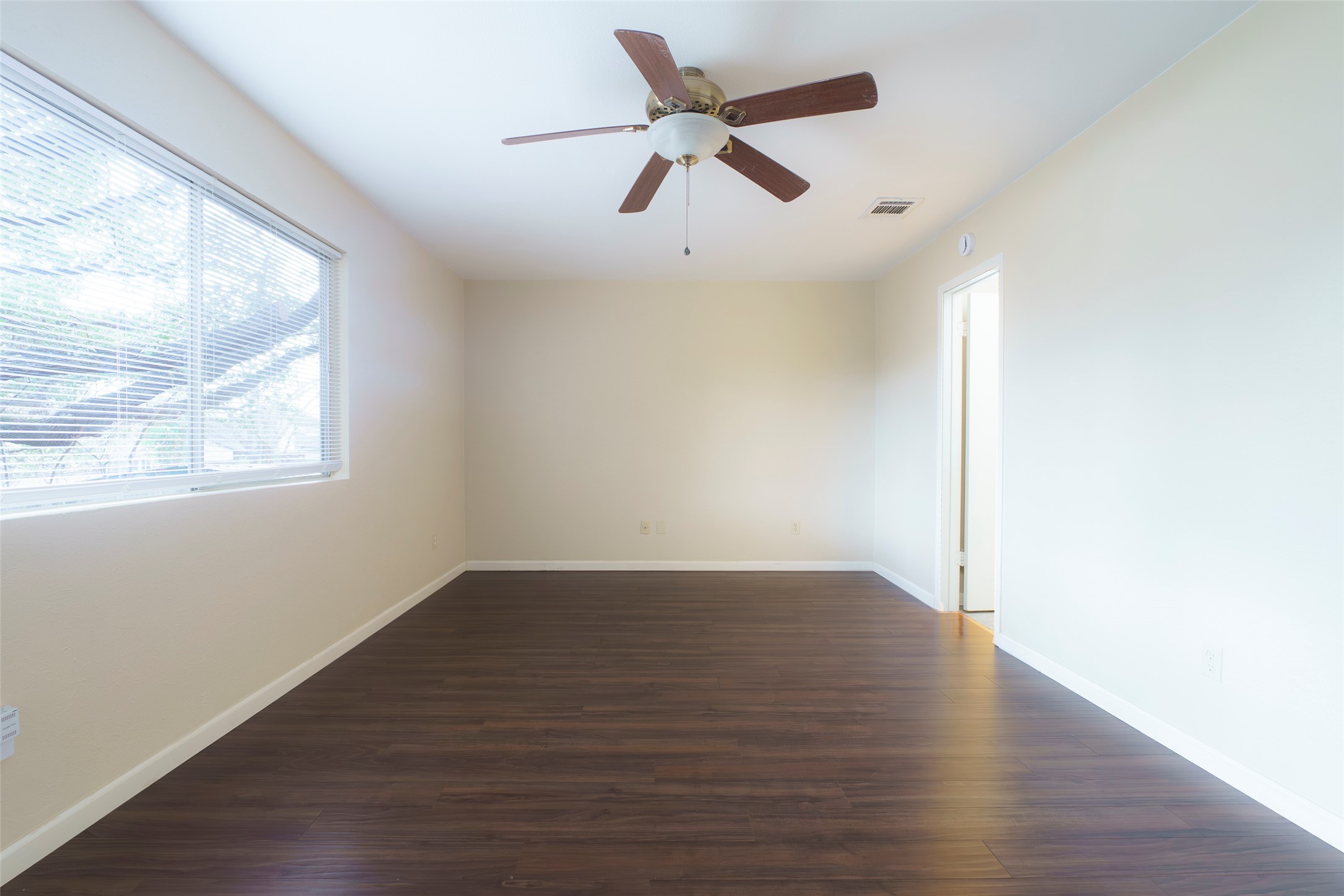 5603 Porsche Lane Austin, TX 78749 - Photo 13 of 25 an empty room with wooden floor fan and windows