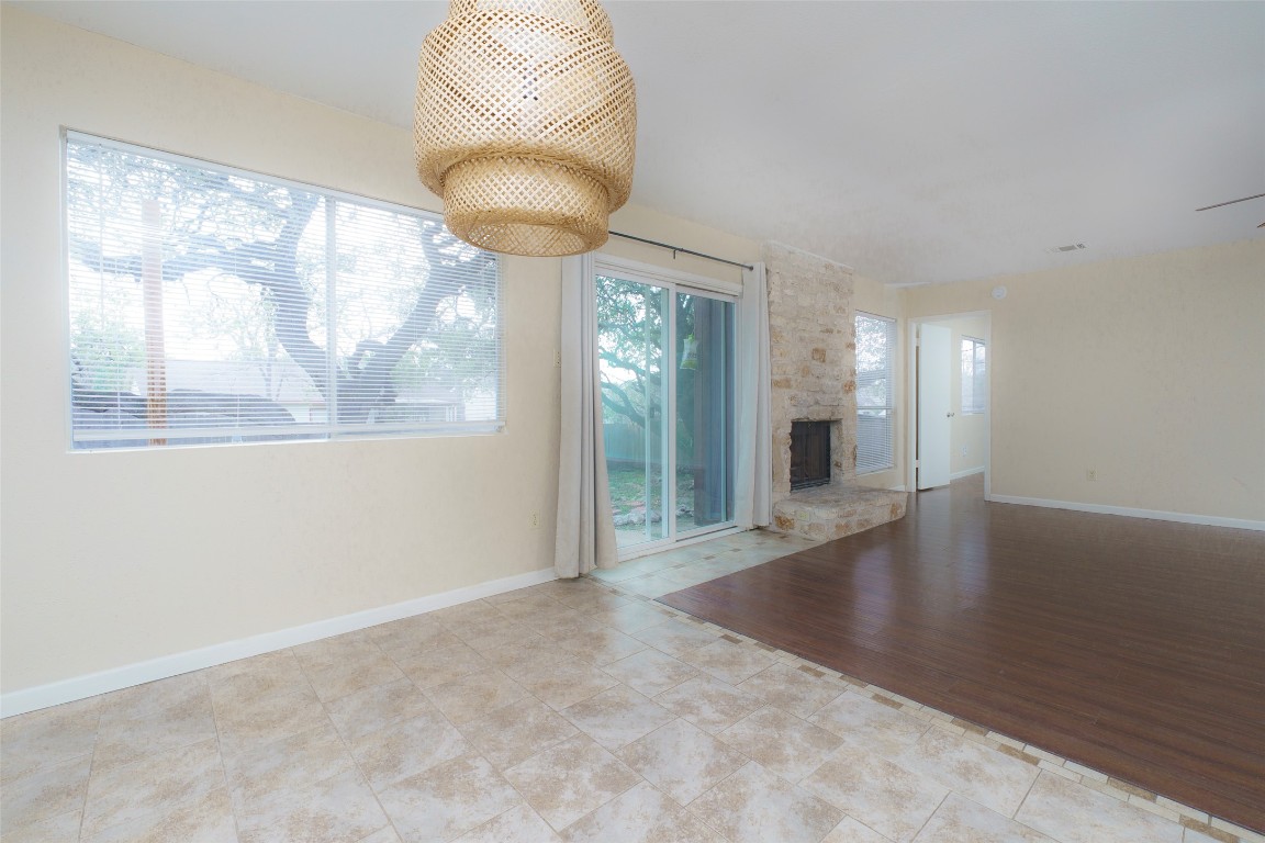 5603 Porsche Lane Austin, TX 78749 - Photo 6 of 25 an empty room with a large window and wooden floor