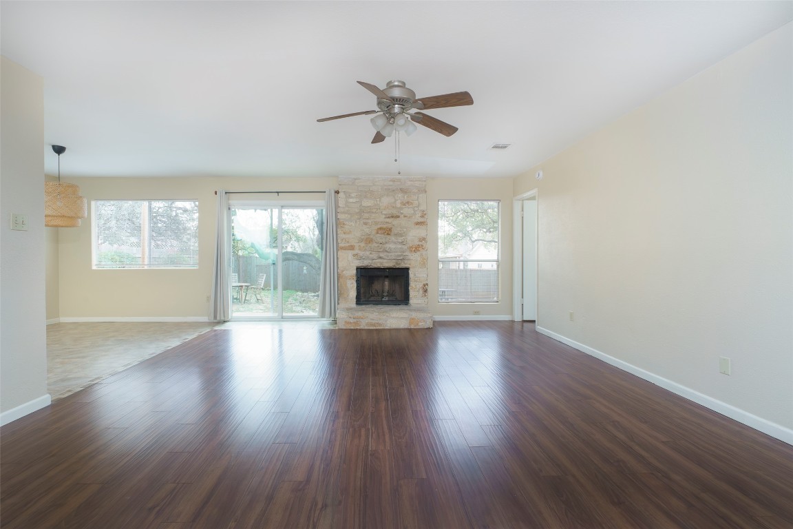 5603 Porsche Lane Austin, TX 78749 - Photo 8 of 25 an empty room with wooden floor chandelier and windows