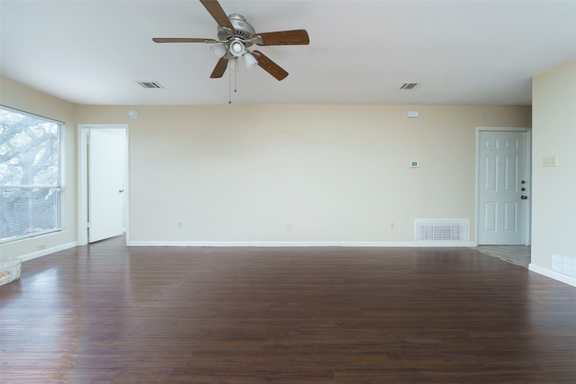 5603 Porsche Lane Austin, TX 78749 - Photo 9 of 25 a view of an empty room with wooden floor and a window