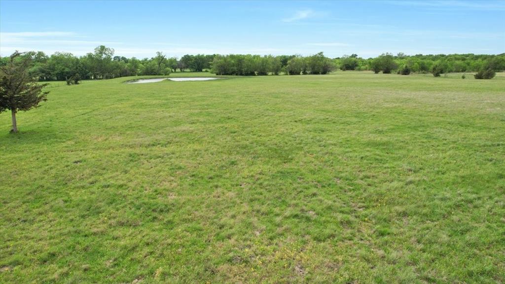 99 East Line Road Whitewright, TX 75491 - Photo 4 of 10 a view of a lake with a yard