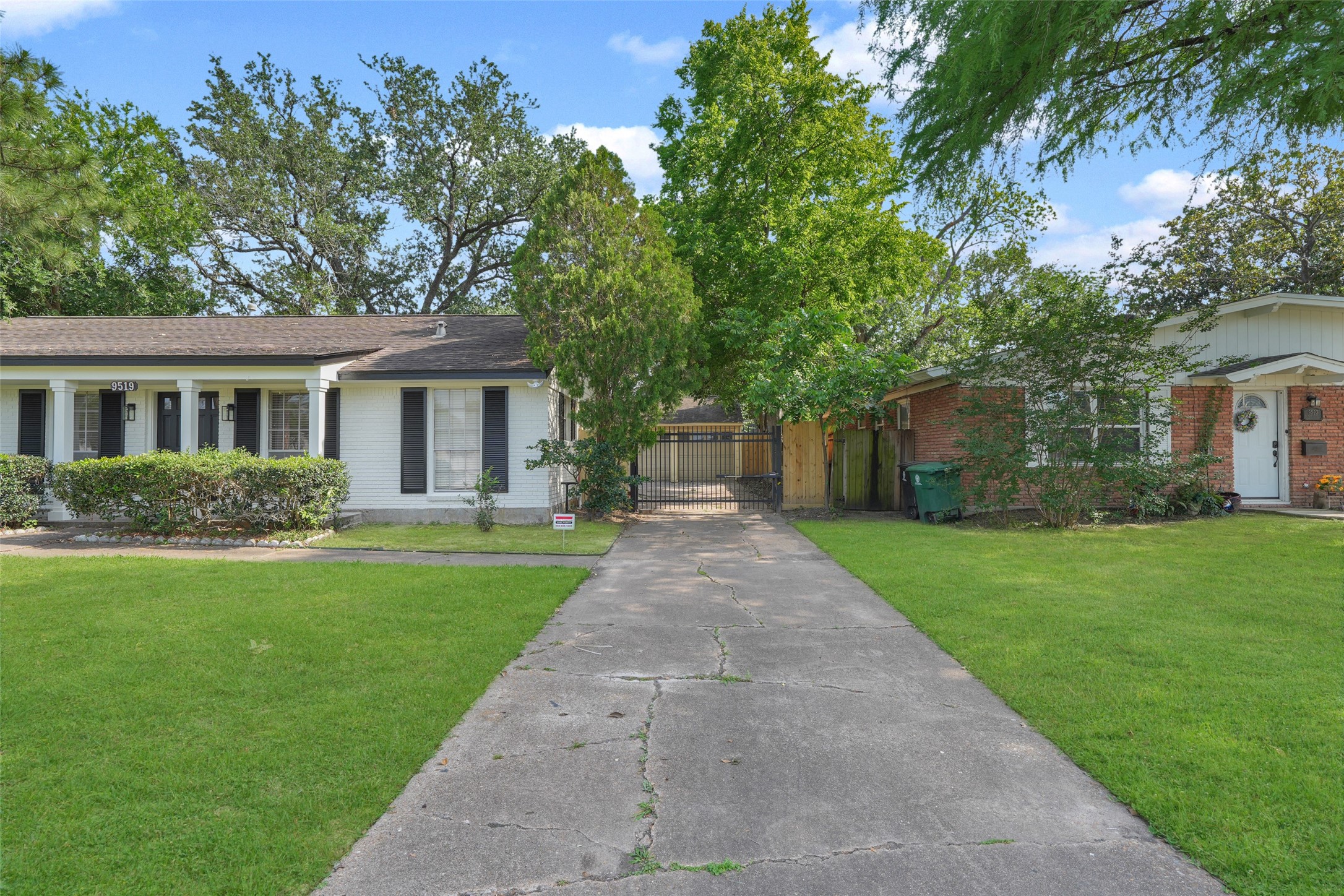 9519 Val Verde Street Houston, TX 77063 - Photo 2 of 27 Charming single-story home with a classic exterior, featuring a long driveway, well-maintained lawn, and mature trees. The front porch adds to the welcoming curb appeal.