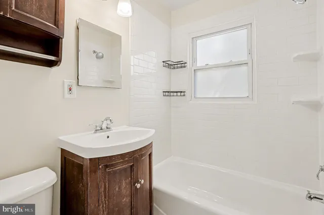 a bathroom with a sink a toilet and a bathtub
