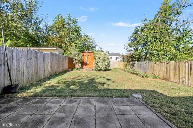 a view of a backyard with wooden fence