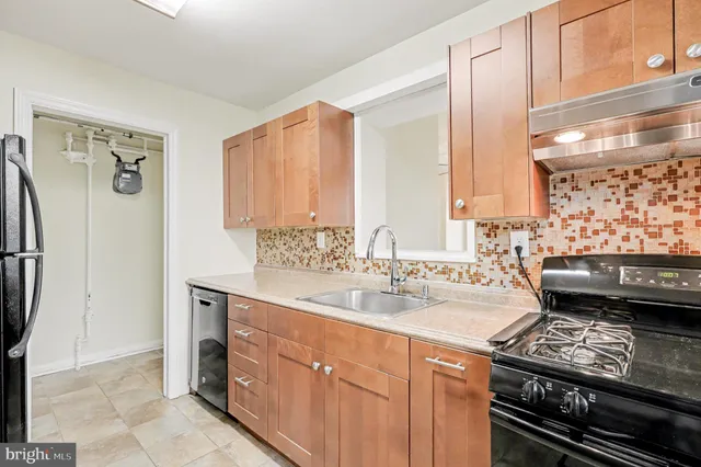 a kitchen with a sink stove and refrigerator