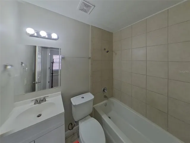a bathroom with a sink mirror toilet and bathtub