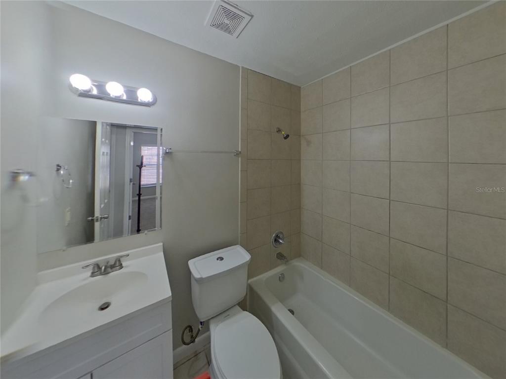 Undisclosed Address Brandon, FL 33510 - Photo 15 of 17 a bathroom with a sink mirror toilet and bathtub