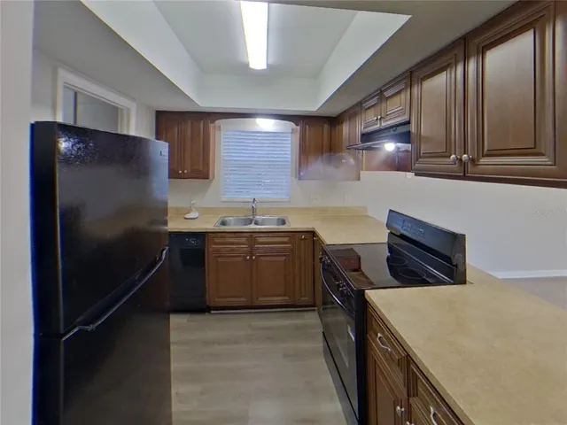 a kitchen with a refrigerator and a sink