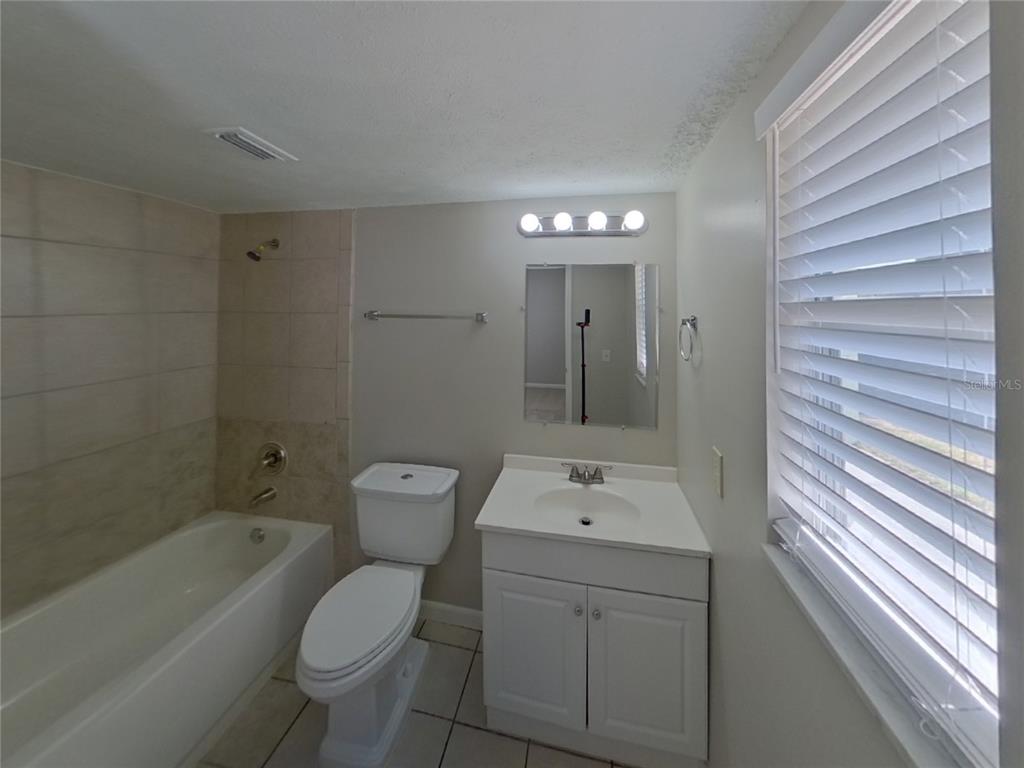 Undisclosed Address Brandon, FL 33510 - Photo 8 of 17 a bathroom with a sink a toilet and shower