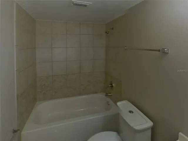 a bathroom with a bathtub and toilet