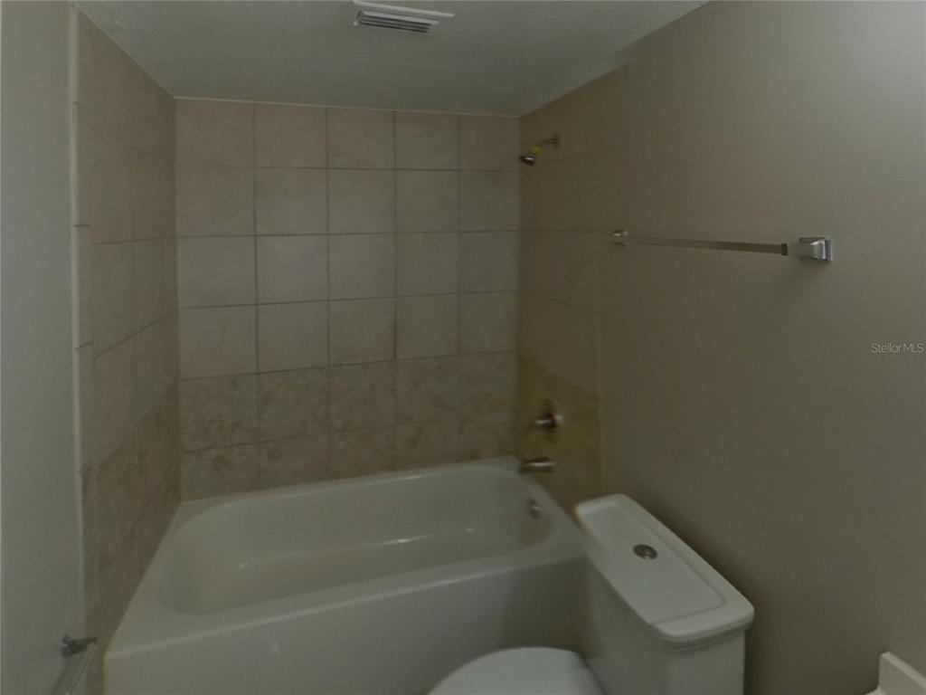 Undisclosed Address Brandon, FL 33510 - Photo 9 of 17 a bathroom with a bathtub and toilet
