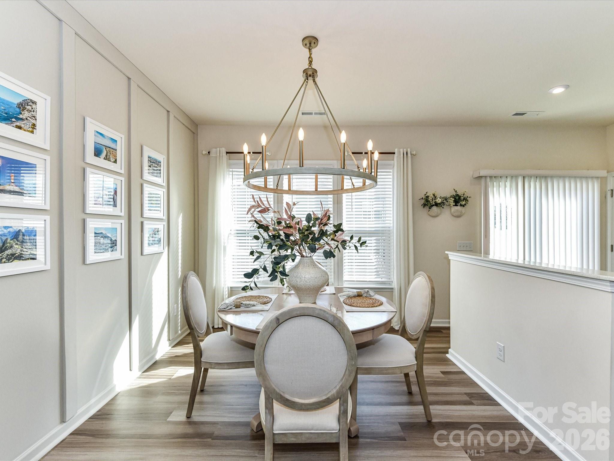 806 Canoe Song Road Fort Mill, SC 29708 - Photo 1 of 39 a view of a dining room with furniture window and wooden floor