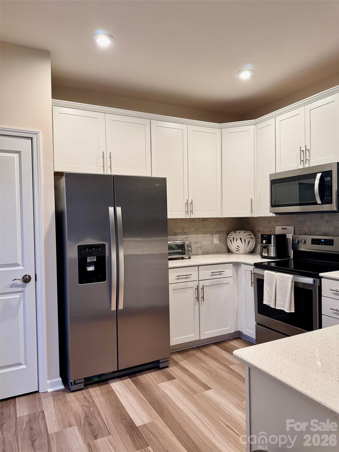 806 Canoe Song Road Fort Mill, SC 29708 - Photo 11 of 39 a kitchen with a refrigerator sink and white cabinets
