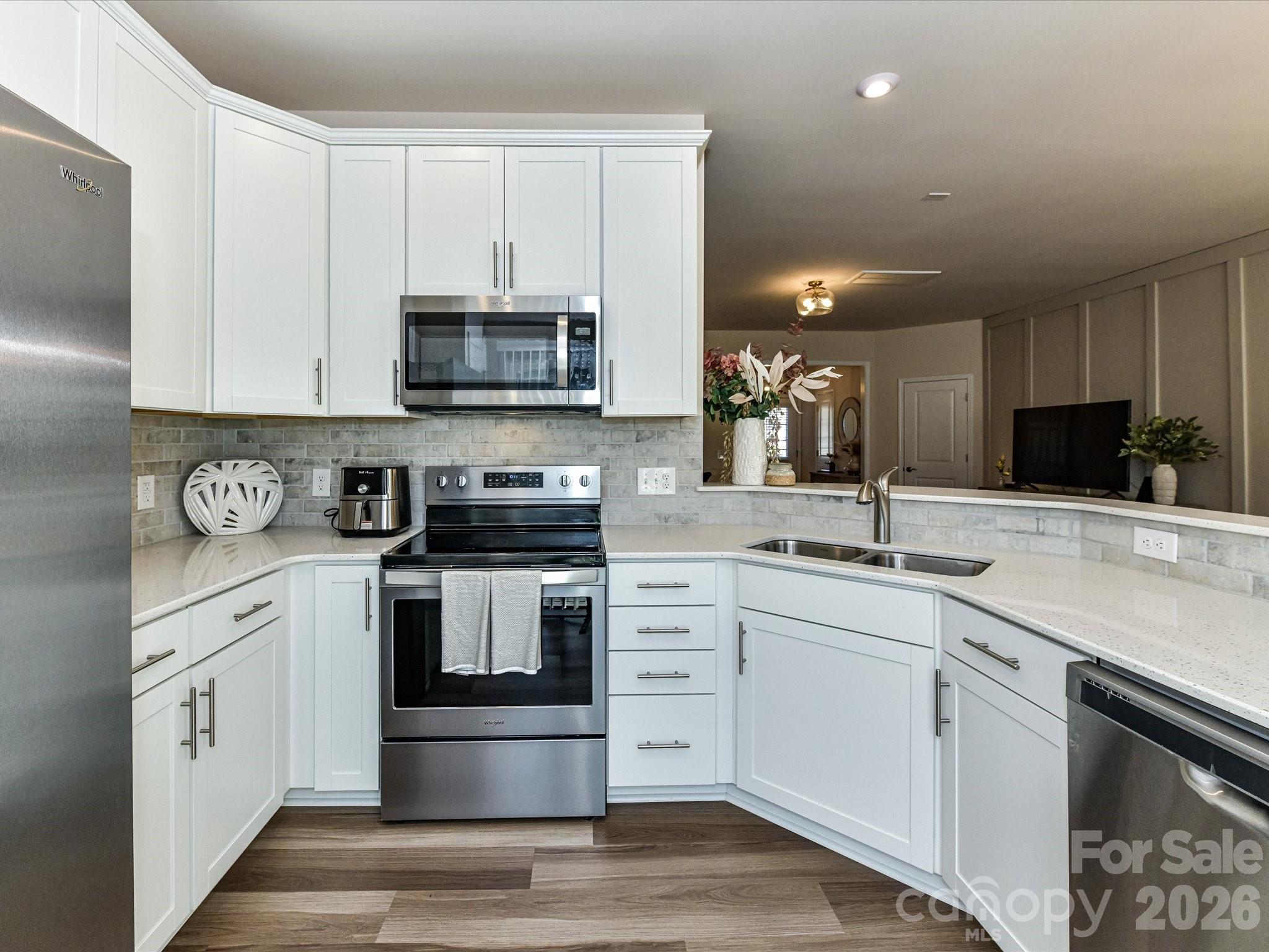 806 Canoe Song Road Fort Mill, SC 29708 - Photo 13 of 39 a kitchen with stainless steel appliances granite countertop a sink and cabinets