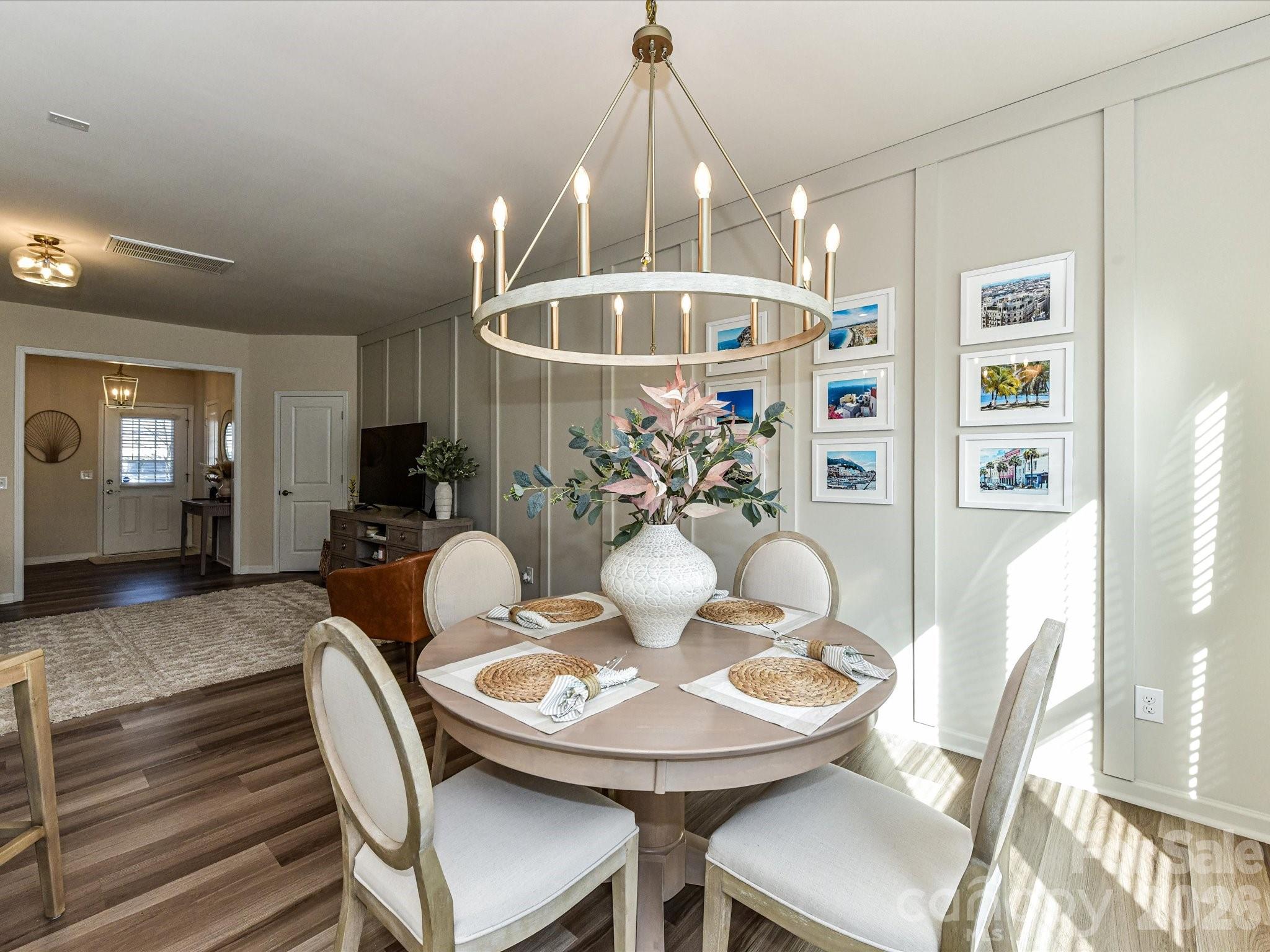 806 Canoe Song Road Fort Mill, SC 29708 - Photo 15 of 39 a view of a dining room with furniture and wooden floor