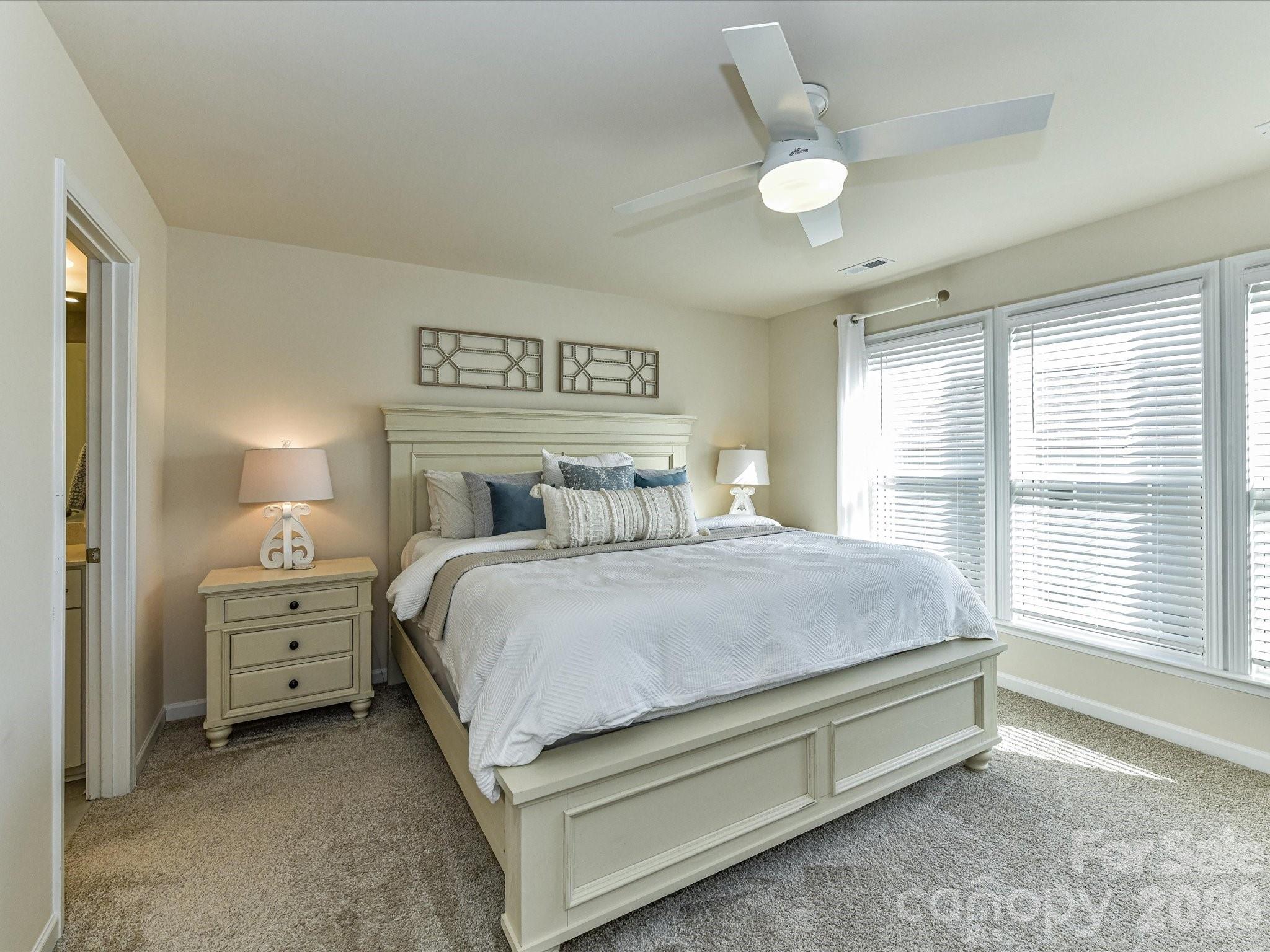 806 Canoe Song Road Fort Mill, SC 29708 - Photo 17 of 39 a bedroom with a bed and a large window