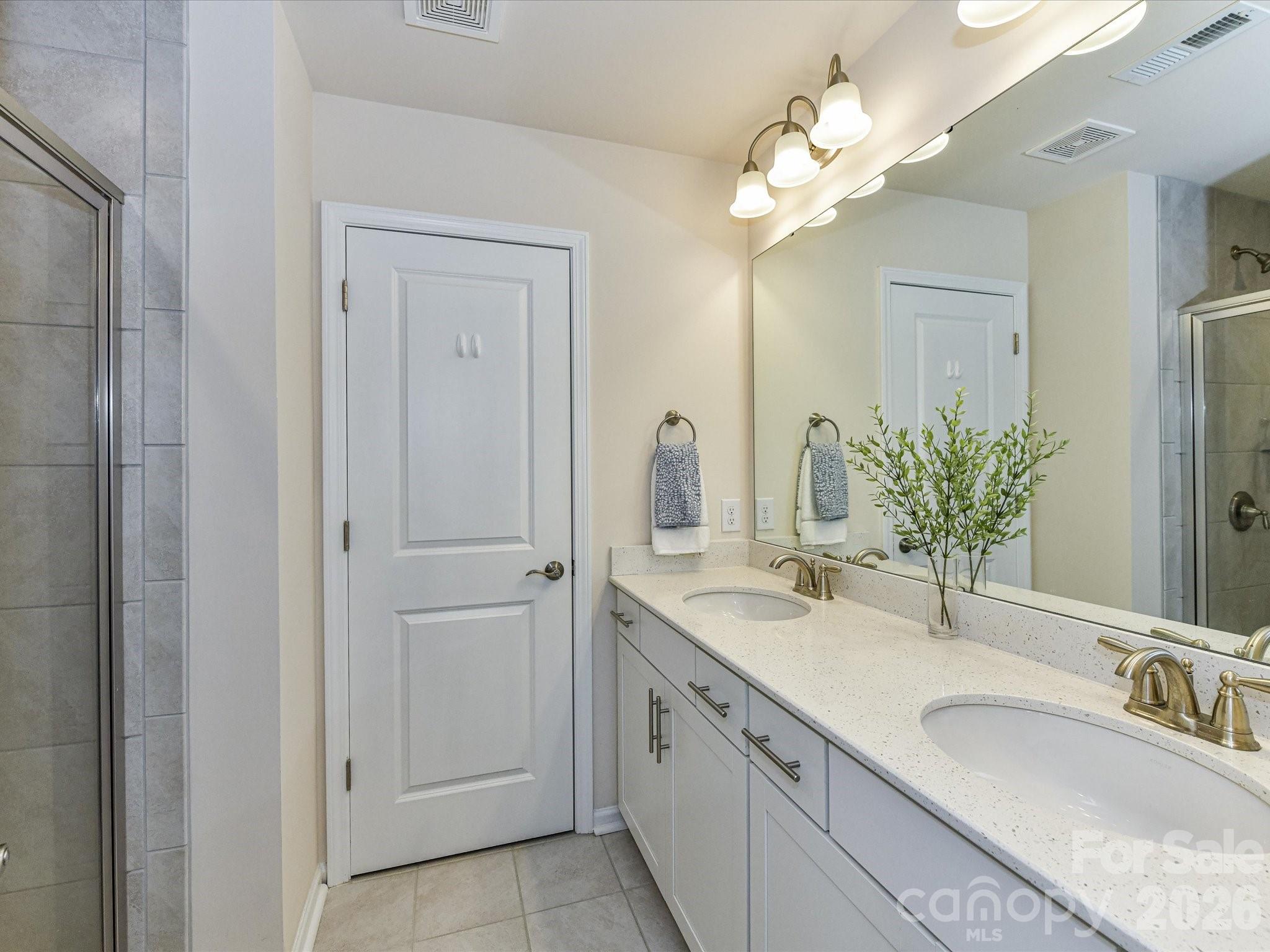 806 Canoe Song Road Fort Mill, SC 29708 - Photo 19 of 39 a bathroom with a double vanity sink and a mirror