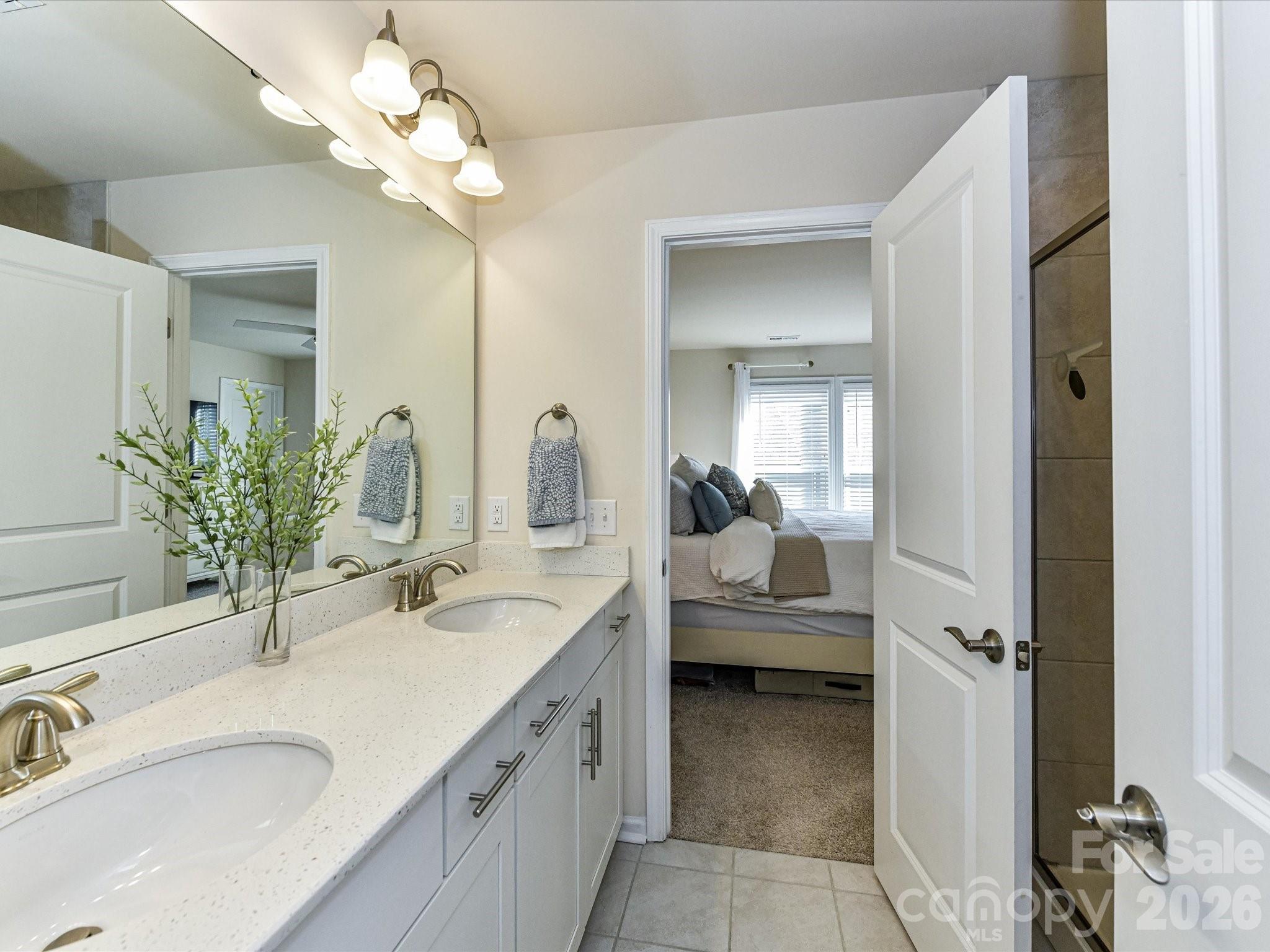 806 Canoe Song Road Fort Mill, SC 29708 - Photo 21 of 39 a en suite bathroom with a double vanity sink a large mirror and shower