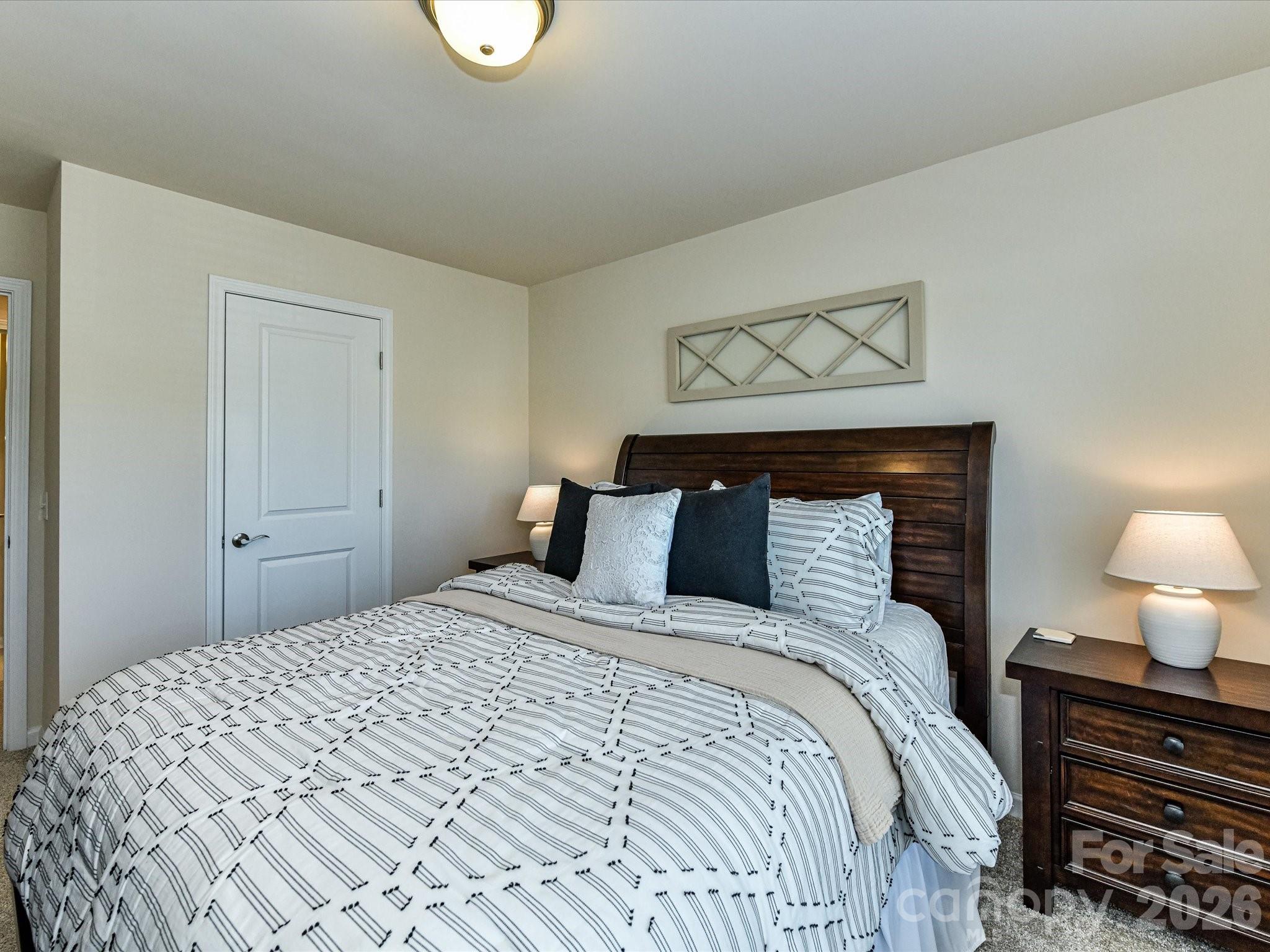 806 Canoe Song Road Fort Mill, SC 29708 - Photo 25 of 39 a bedroom with a bed and lamps