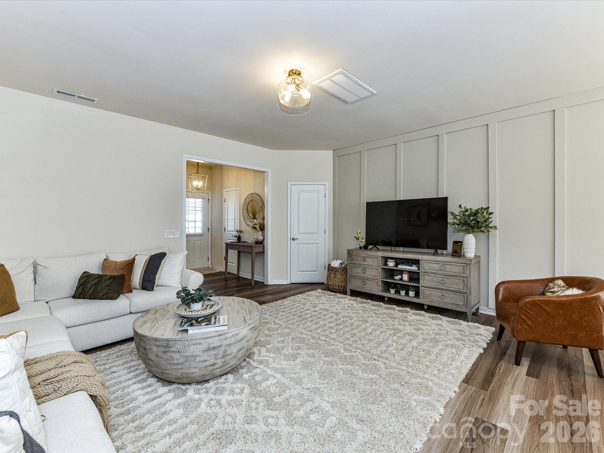 806 Canoe Song Road Fort Mill, SC 29708 - Photo 6 of 39 a living room with furniture and a flat screen tv