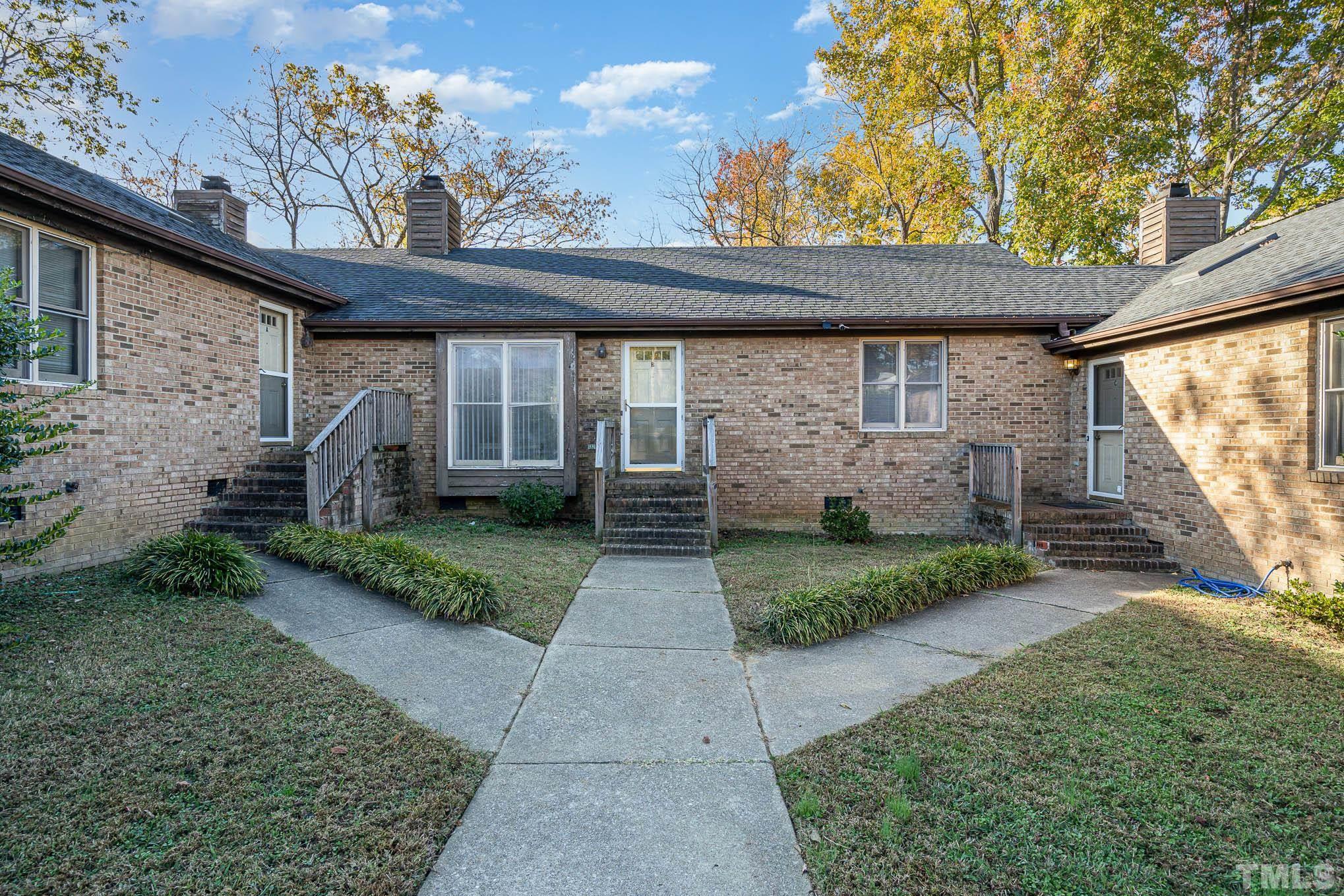 4701 Courtside Place Raleigh, NC 27604 - Photo 1 of 30 a front view of a house with garden