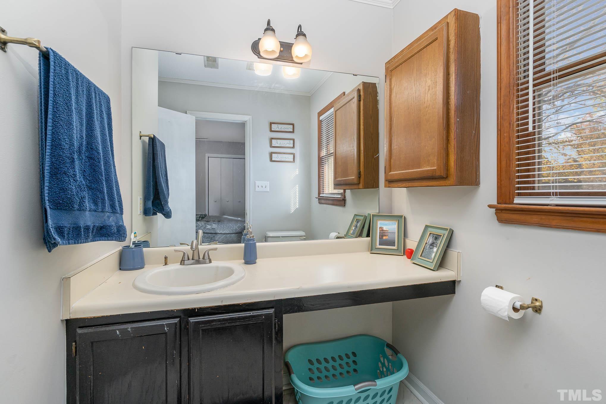4701 Courtside Place Raleigh, NC 27604 - Photo 13 of 30 a bathroom with a sink and a mirror